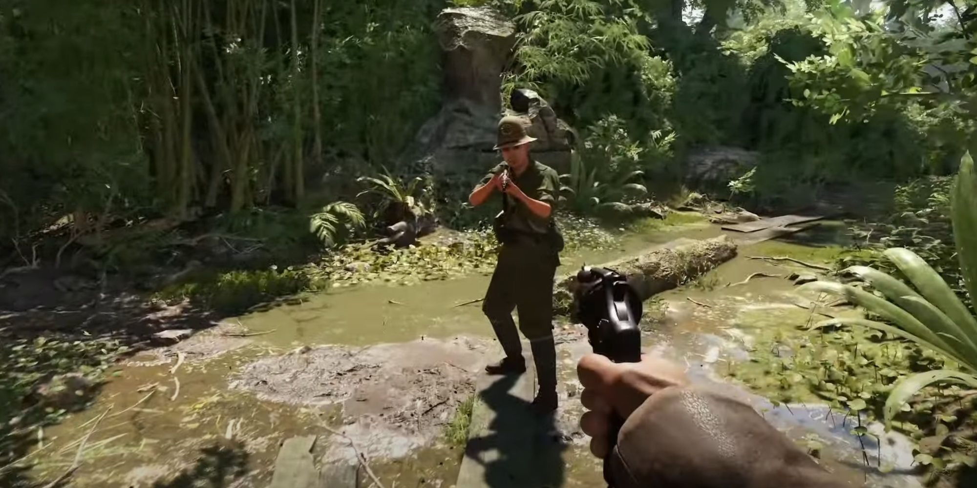 Indiana Jones aiming a pistol at a soldier in a jungle-like environment.