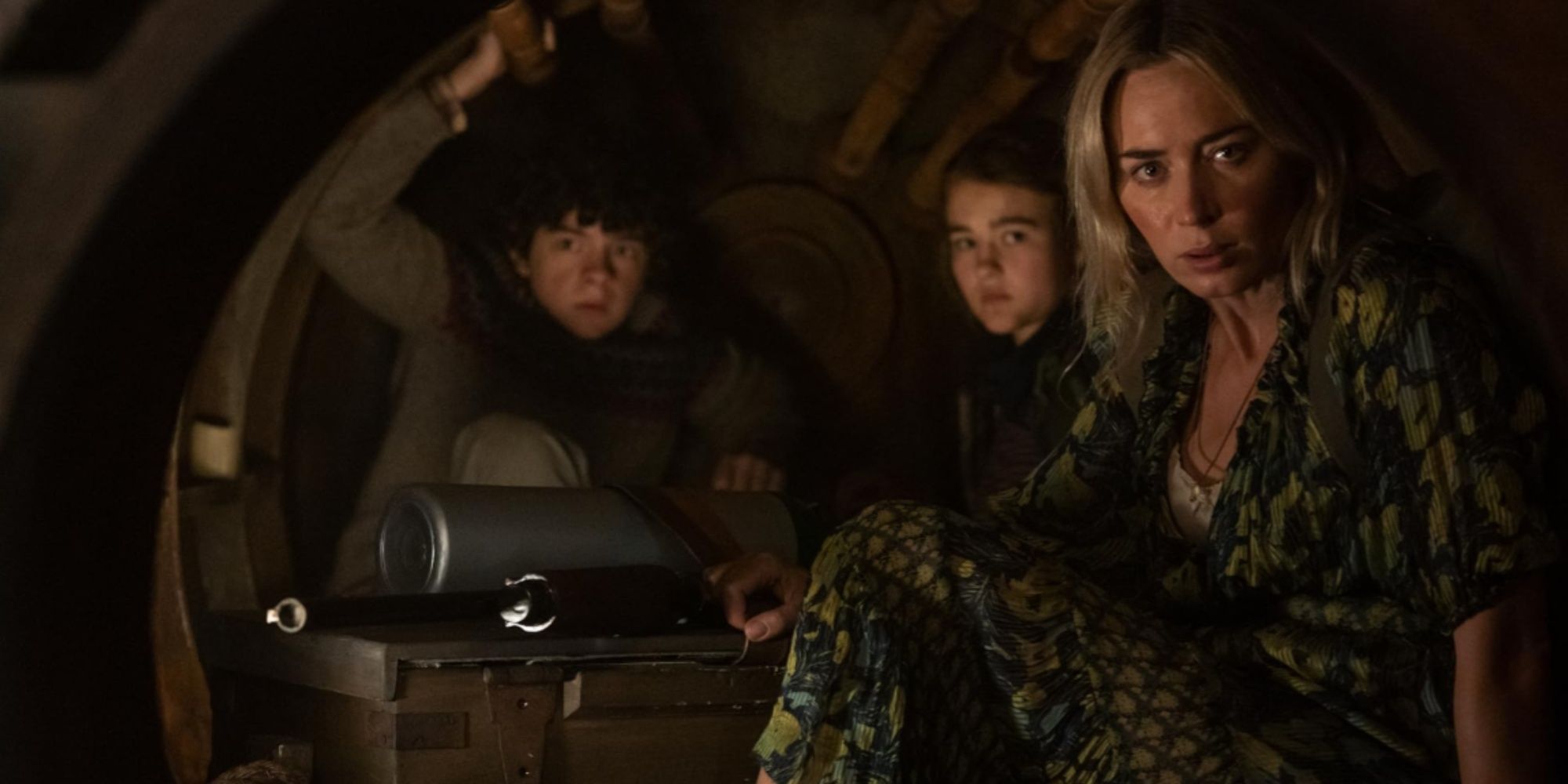 Emily Blunt's Evelyn with her kids Marcus and Regan hiding inside a bunker from the alien threat.