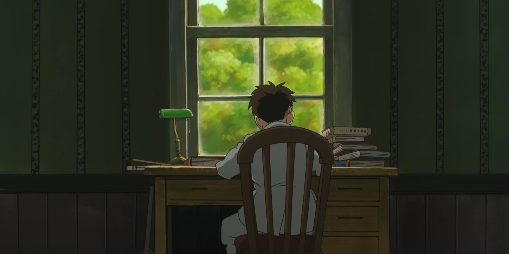 Mahito sits at a desk while reading "How Do You Live?"