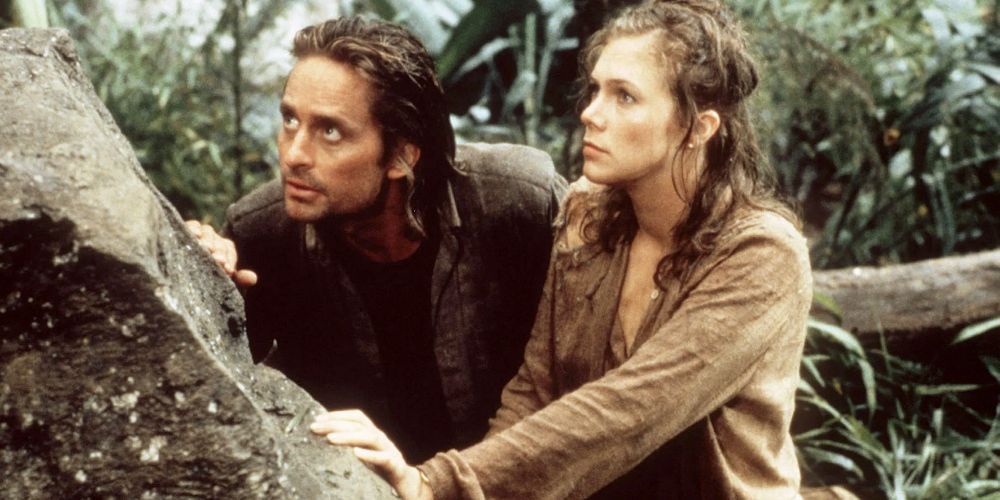 Jack and Joan hide behind a rock in the jungle.