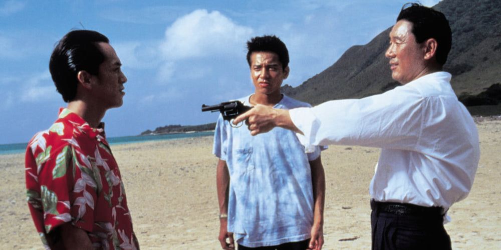 Character pointing a gun at man in red Hawaiian shirt