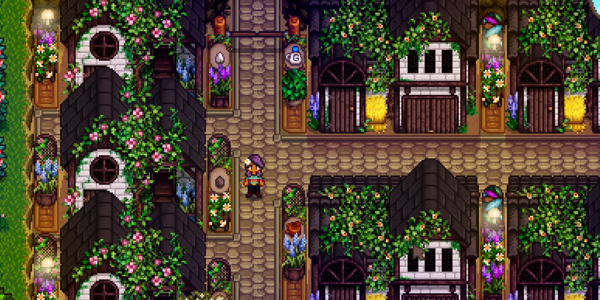 Stardew Valley farmer standing near coops and barns with lights between them at night.