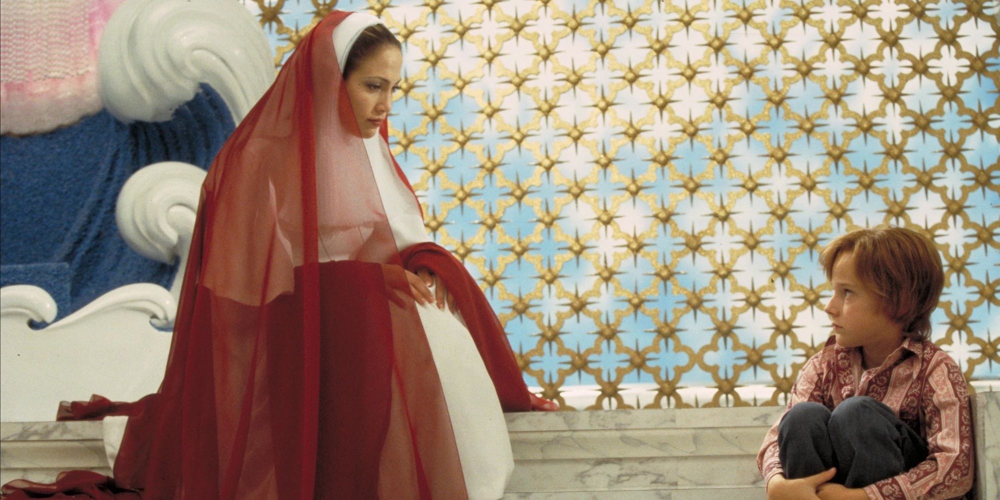 Jennifer Lopez In Red And White Dress Next To A Child