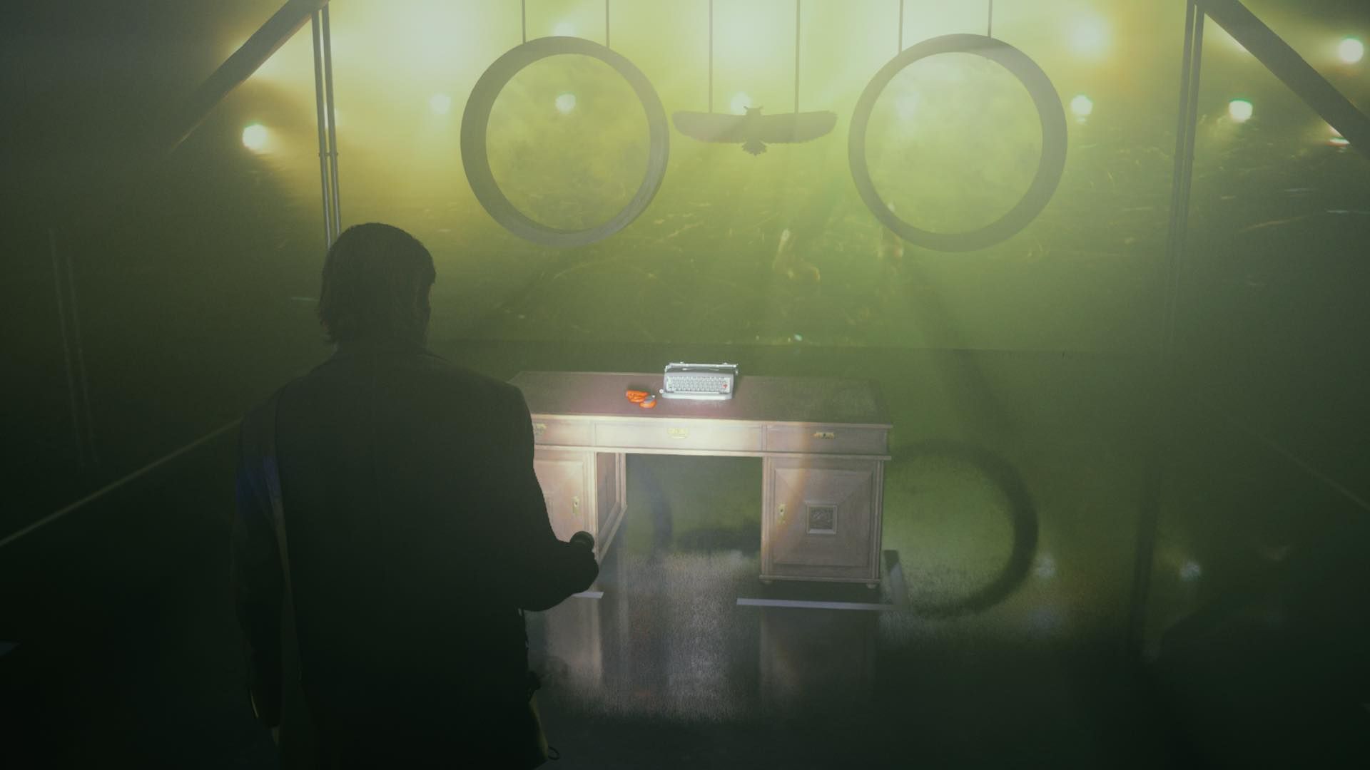 Alan pointing his flashlight at a flare gun sitting on top of a desk inside the talk show studio in Alan Wake 2