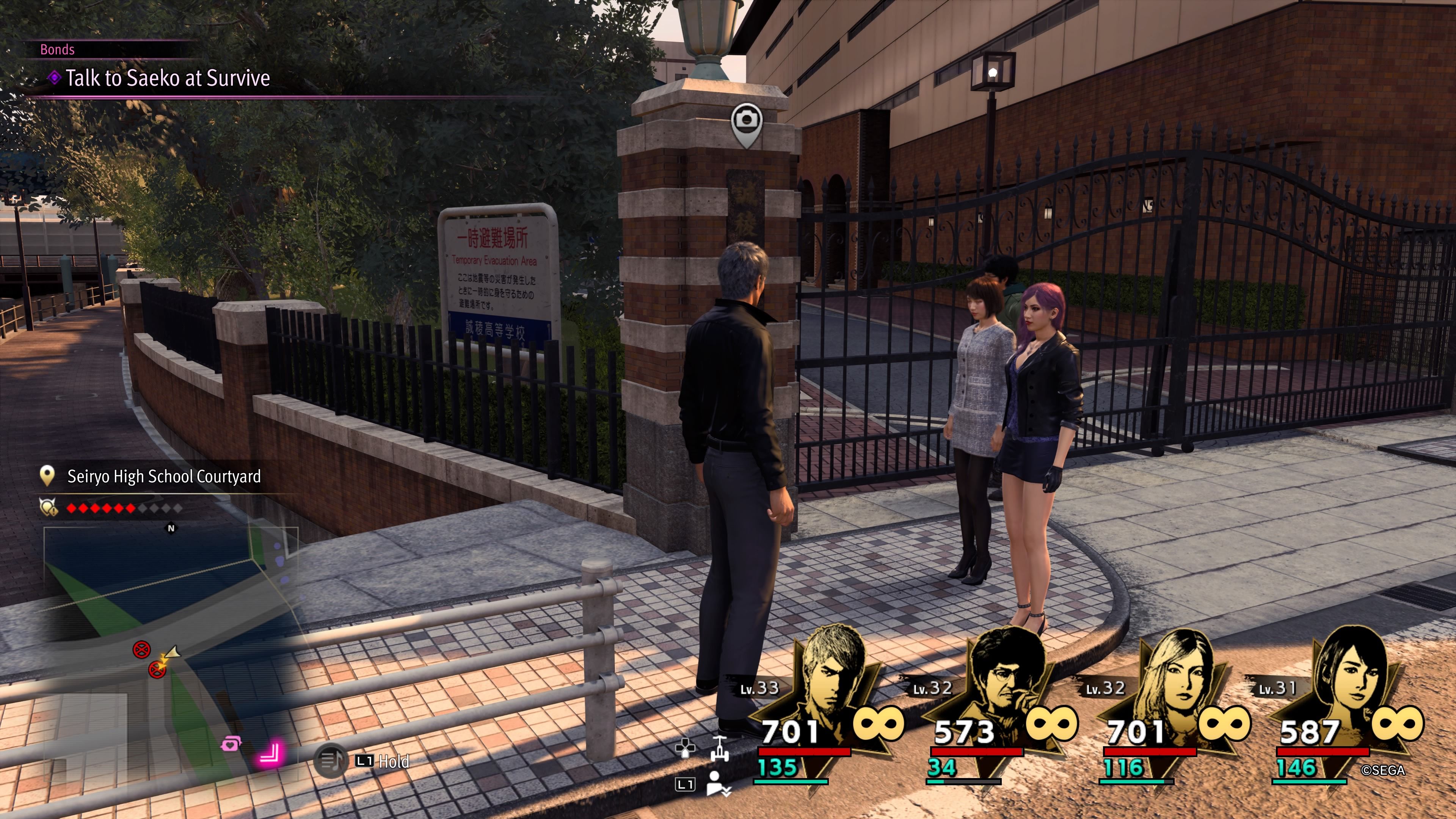 Kiryu, Seonhee, and Saeko standing near the gated entrance to Seiryo Highschool in Like A Dragon: Infinite Wealth.