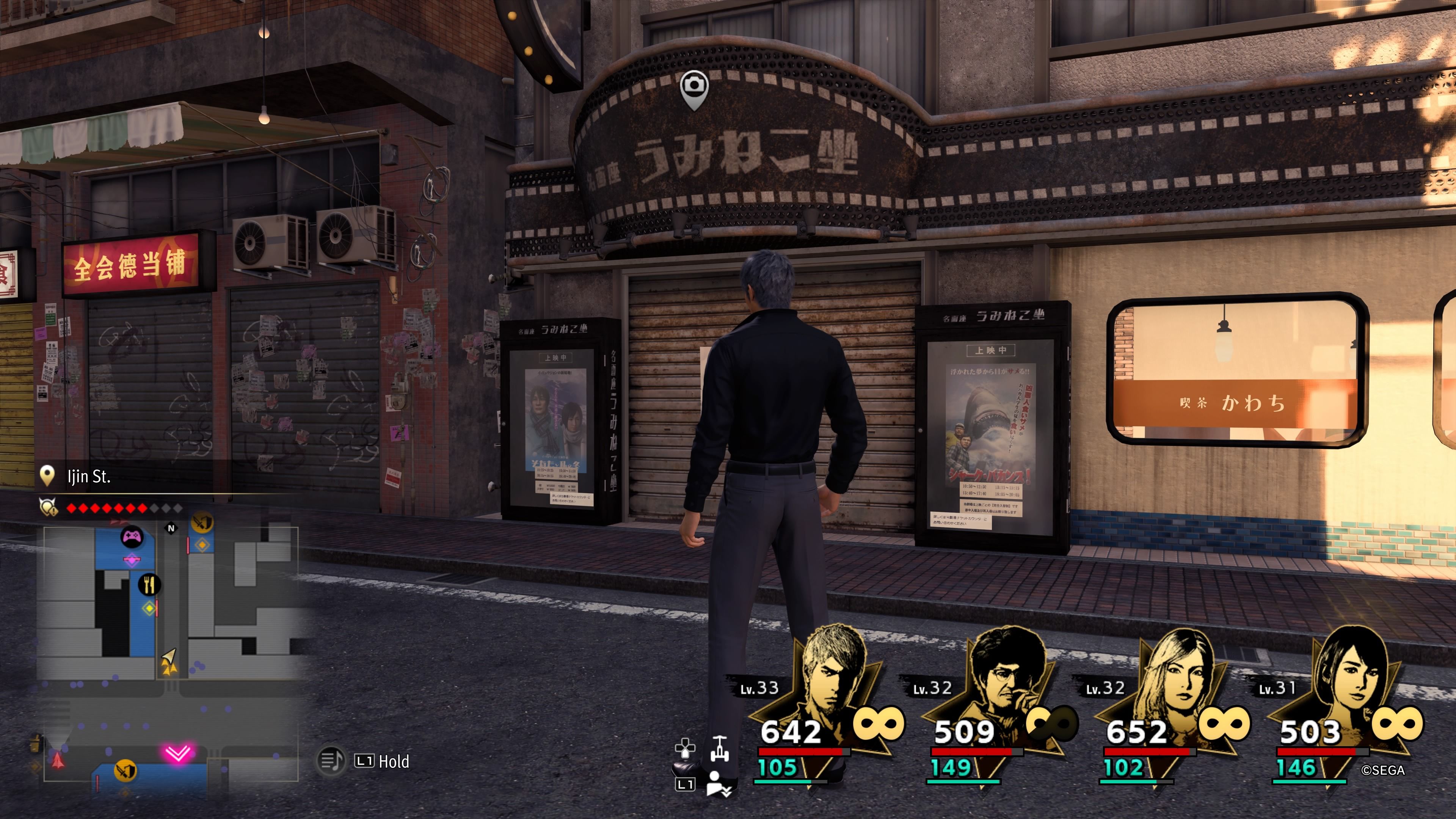 Kiryu standing in front of the shuttered entrance to Seagull Cinema in Like A Dragon: Infinite Wealth.