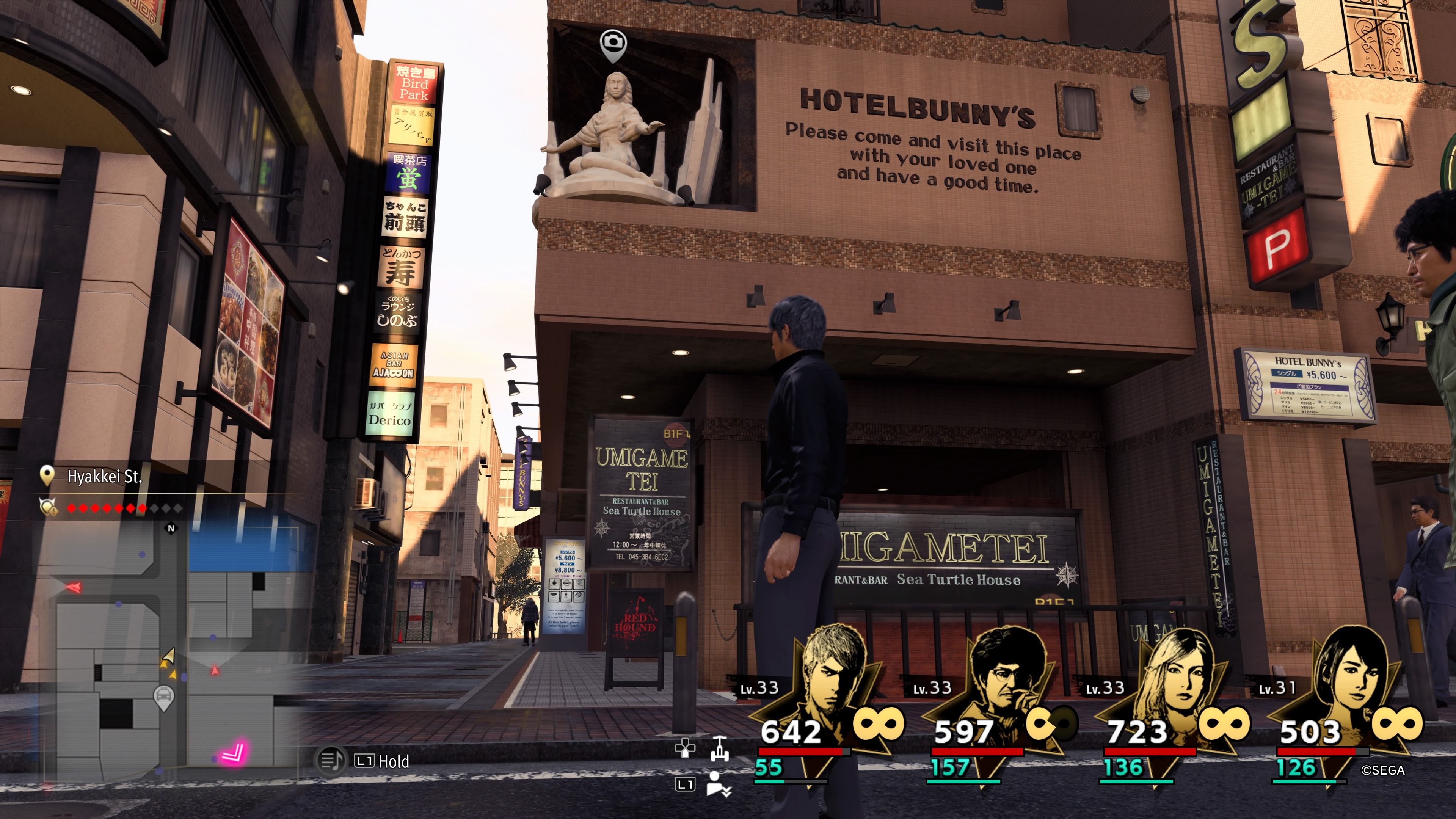Kiryu standing beneath the entrance to Hotel Bunny's in downtown Yokohama in Like A Dragon: Infinite Wealth.