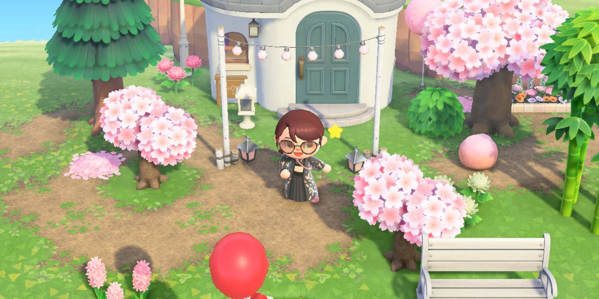 A villager posing in front of Marshal's house, which is decorated for the cherry blossom season