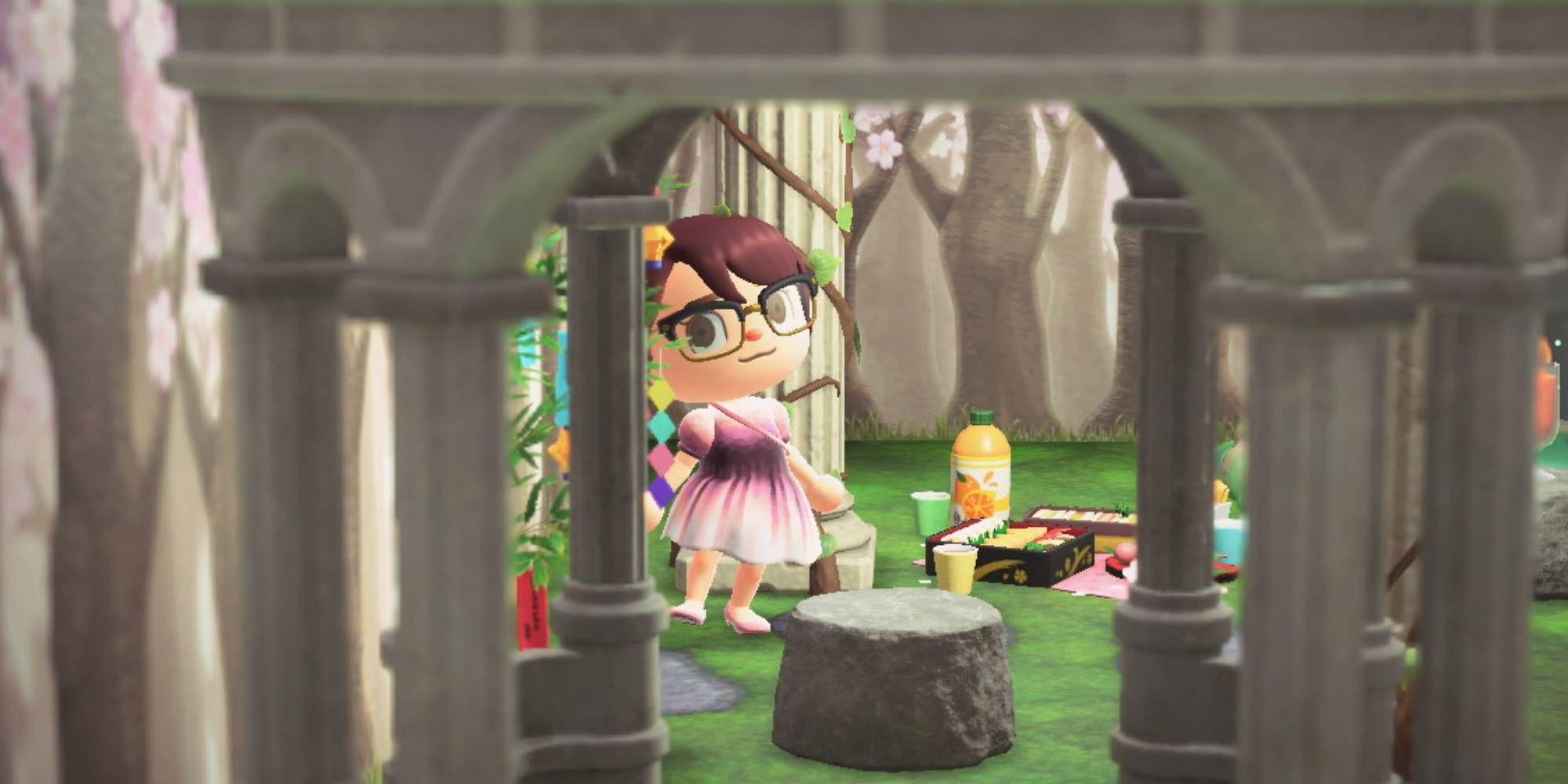 A Villager posing indoors with cherry blossom walls, a grass and stone floor, and a cherry blossom picnic set at their feet