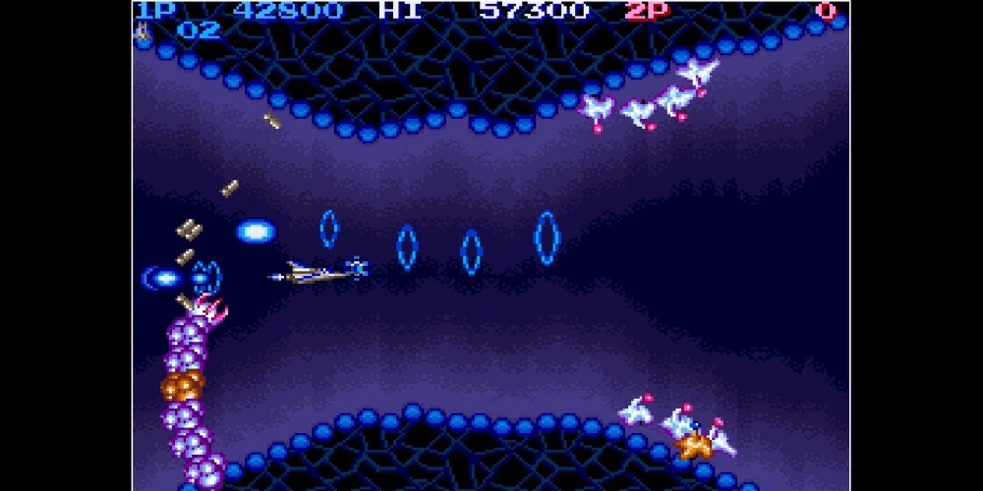 Life Force spaceship flying through a purple level while avoiding enemy fire