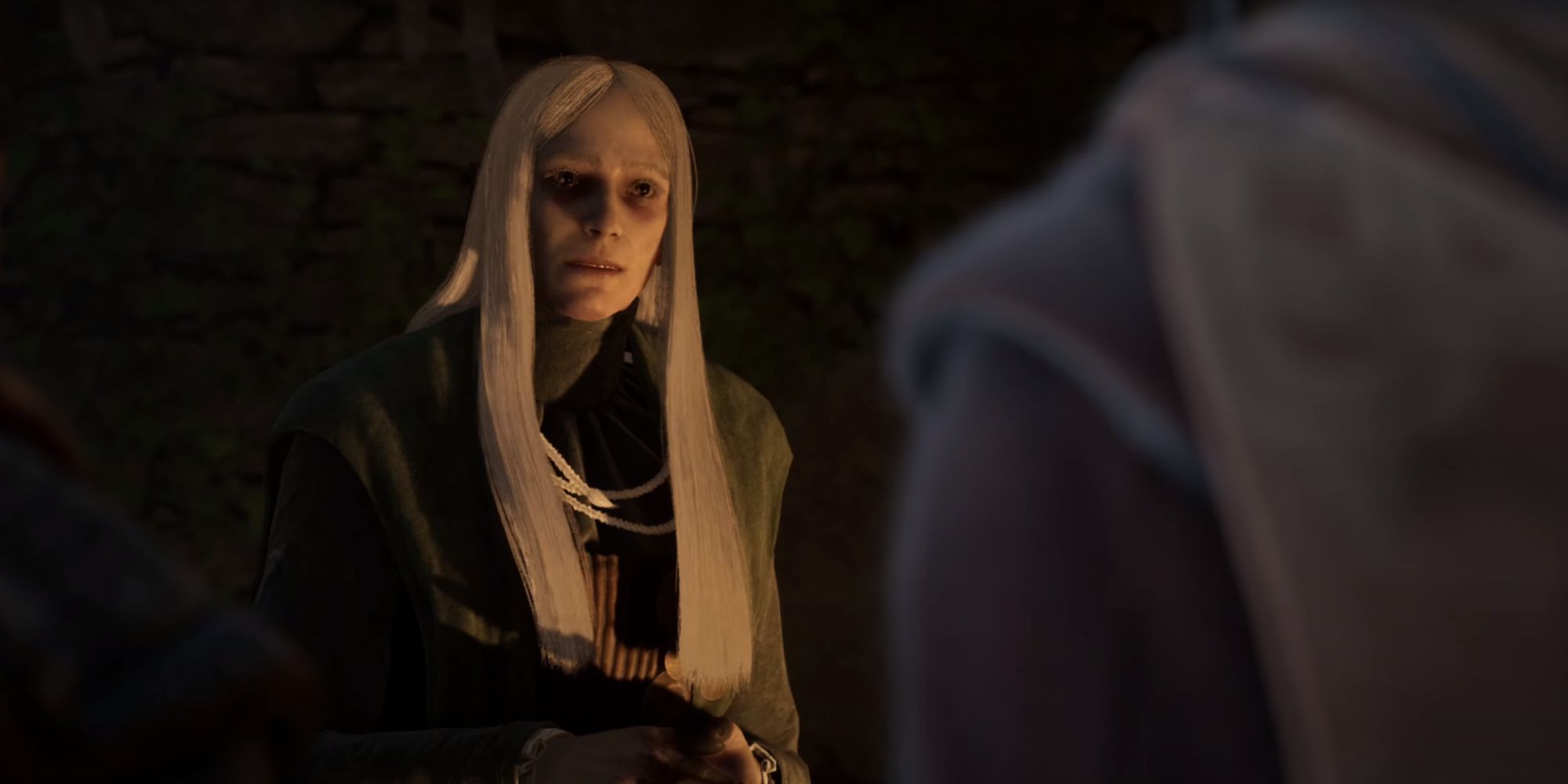 A Witch, seen with black robes, long white hair, and a piercing gaze.