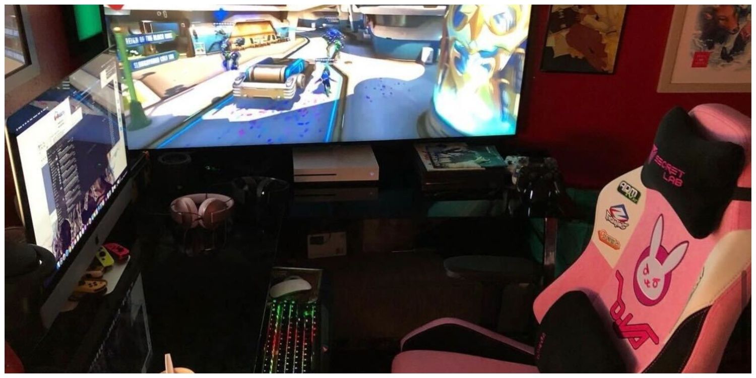 A dual setup of PC and Console, including a pink D.VA SecretLab Chair.