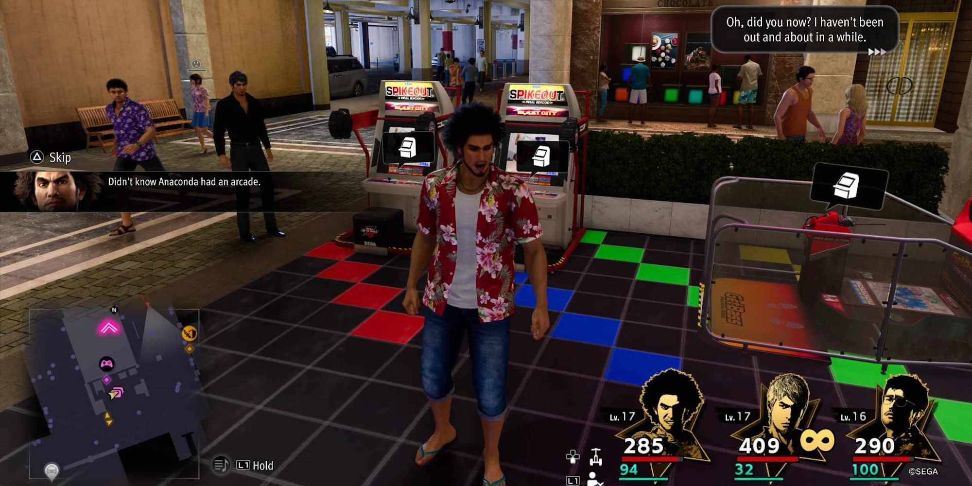 Kasuga standing in the middle of the arcade in the Anaconda Shopping Center