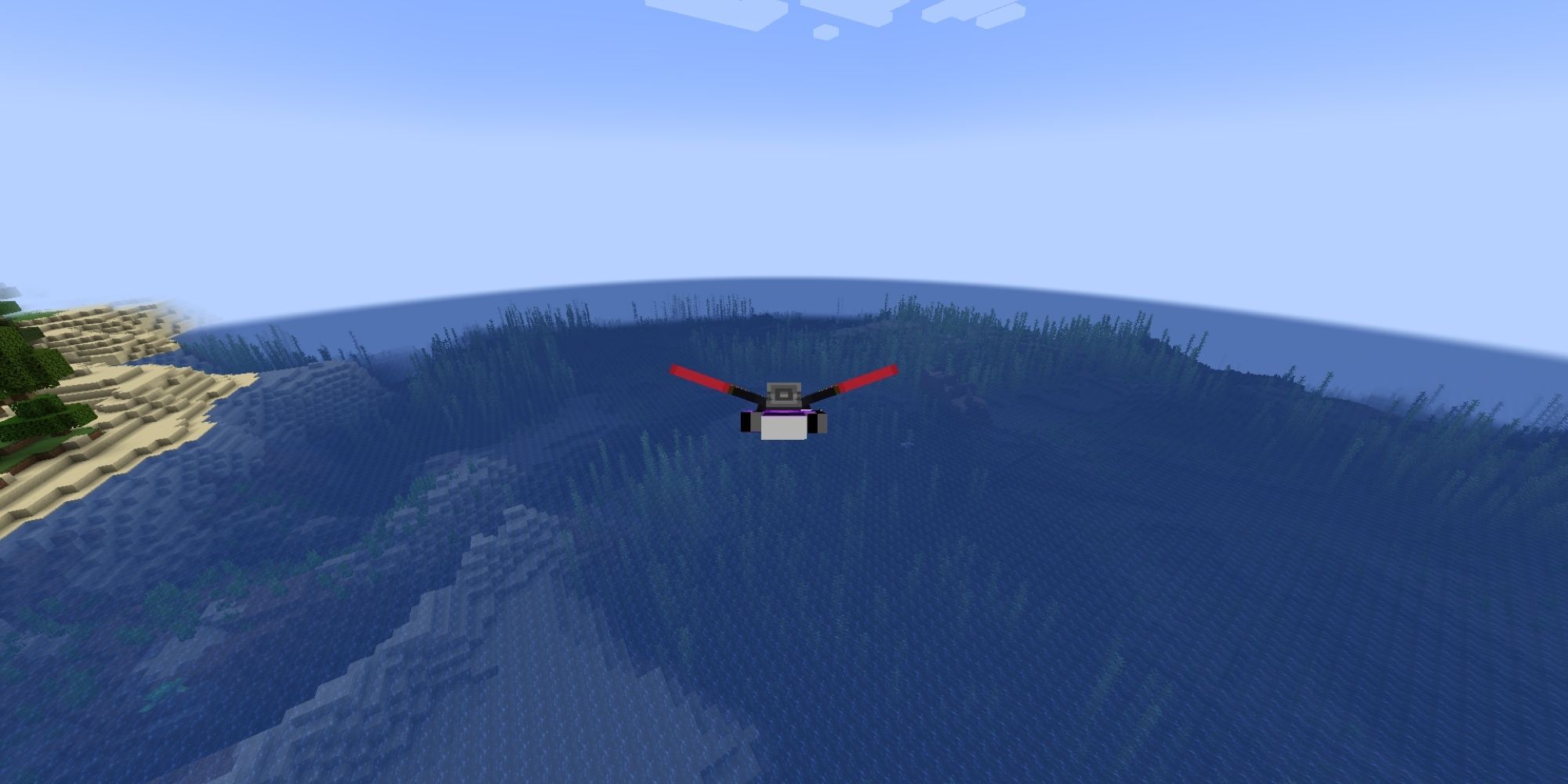 A player flying with an elytra over a large, blue body of water.