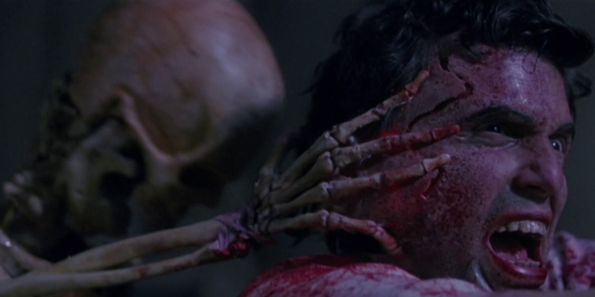 Chris Sarandon's character Charles Dexter Ward getting pulled and cut by a skeleton.