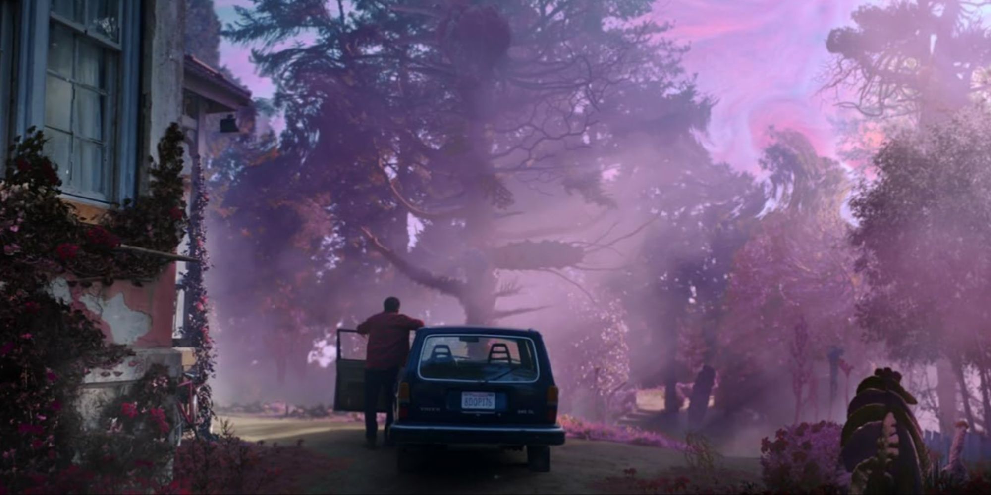 The purple and magenta waves in the sky falling over Nicolas Cage's character getting out of his car.