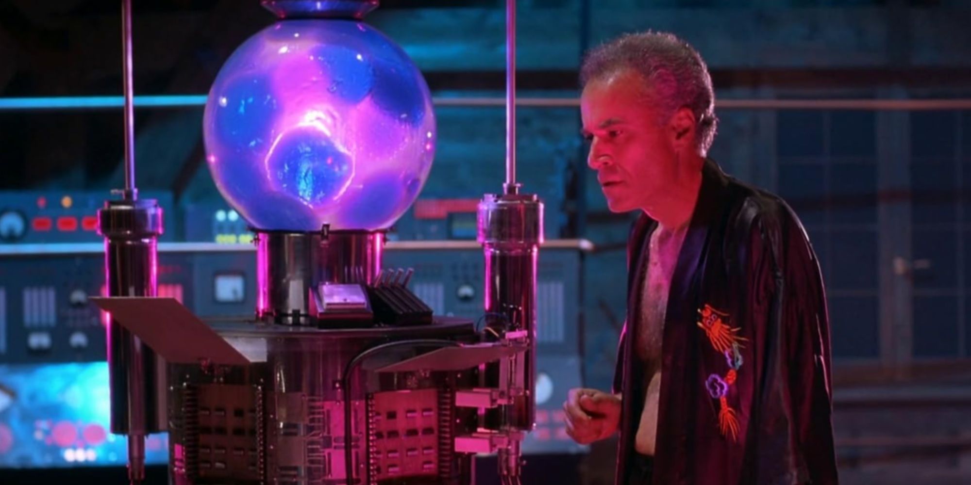 Dr. Pretorius staring into the purple and magenta-glowing orb of the Resonator machine as it's activated.