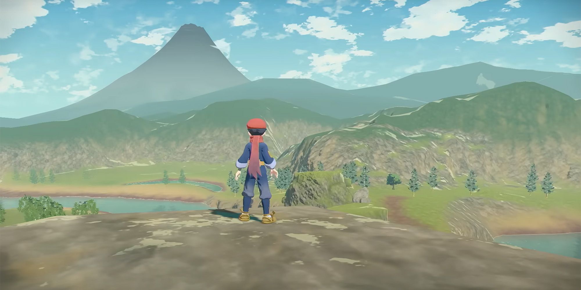 The Pokemon trainer looking at the mountains in Pokemon Legends Arceus.