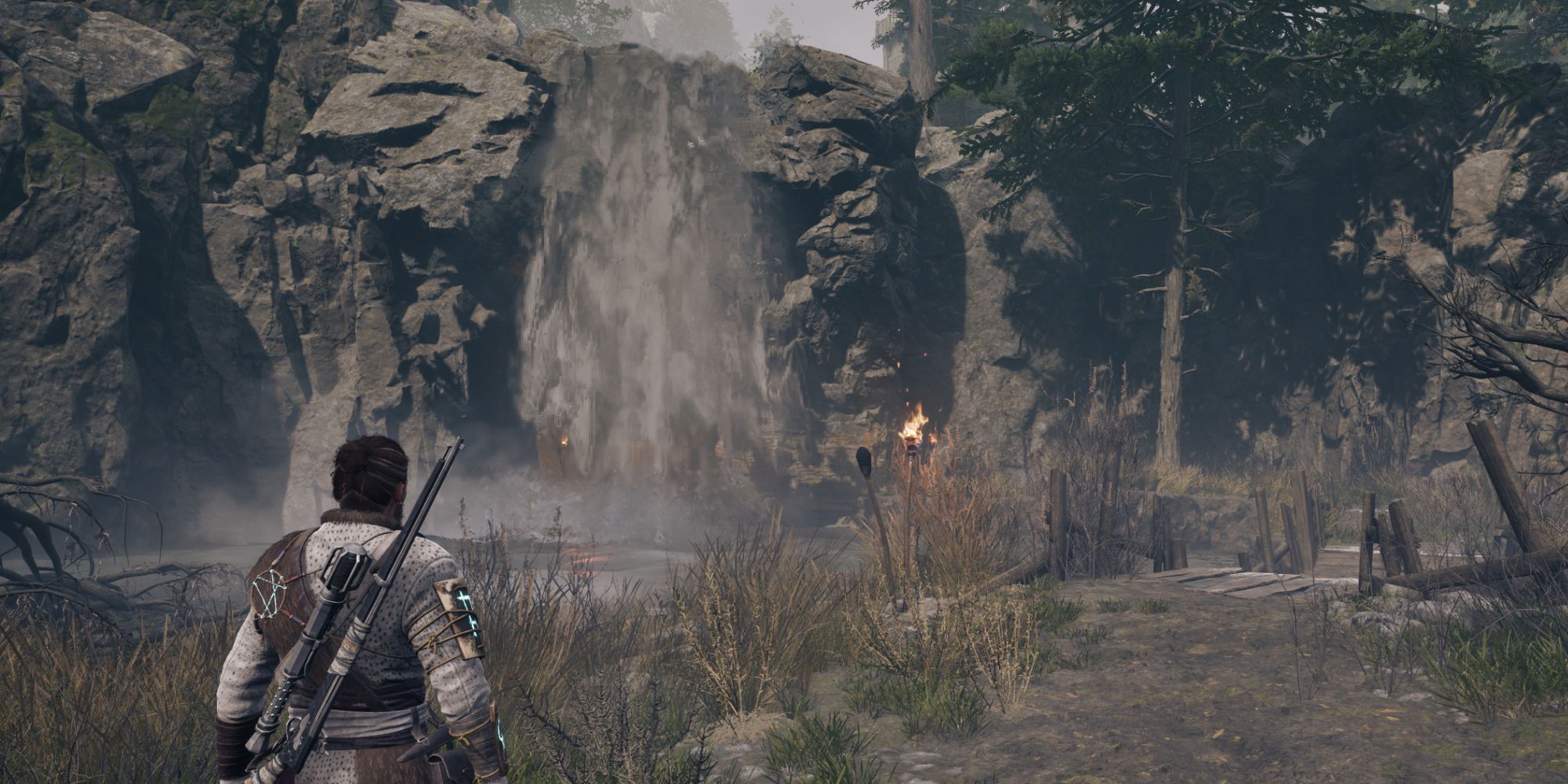 Red is looking at a waterfall that has a hidden cave behind it - Banishers Ghosts of New Eden