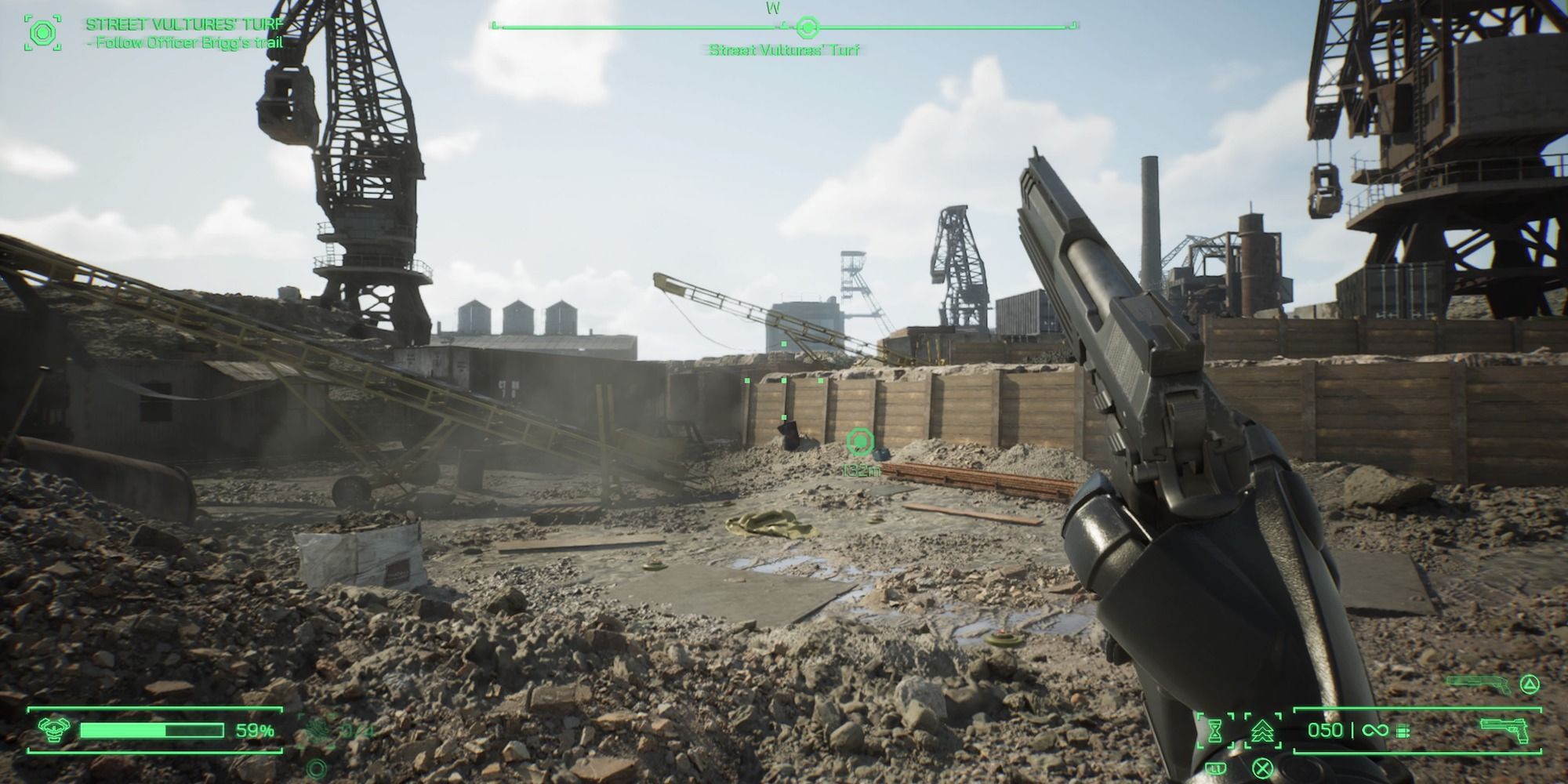Holding a pistol, looking over a junkyard