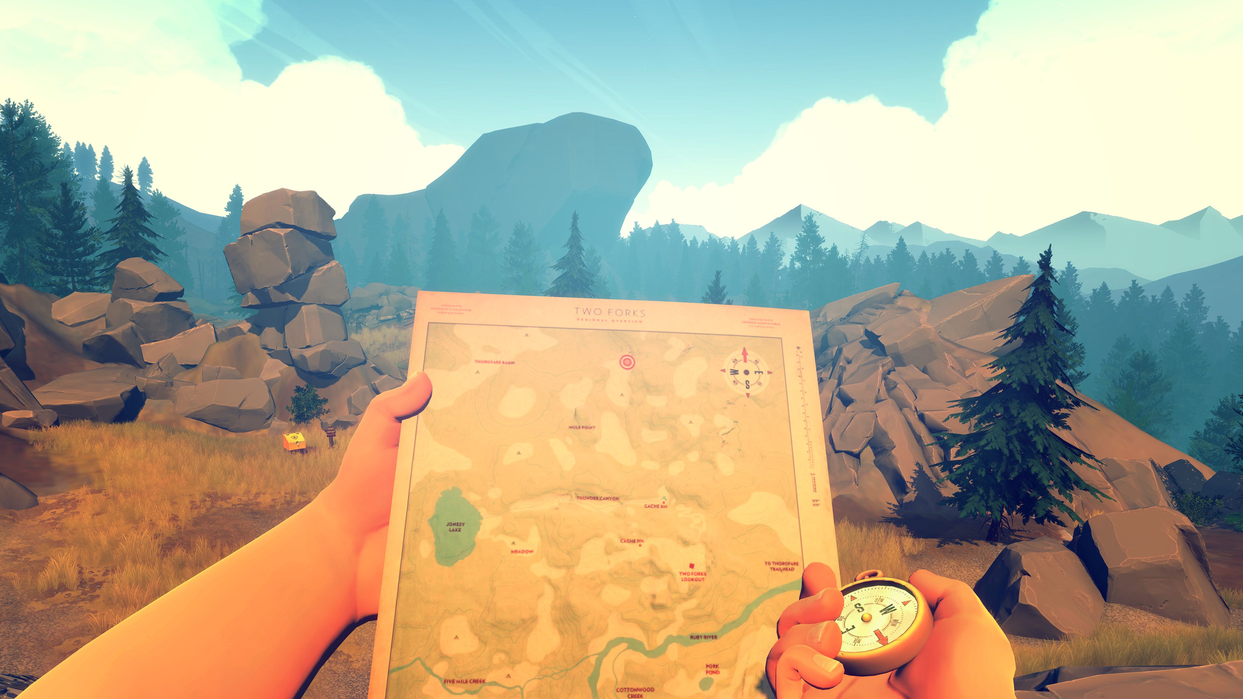 Firewatch - Henry lookin gat his map while holding a compass