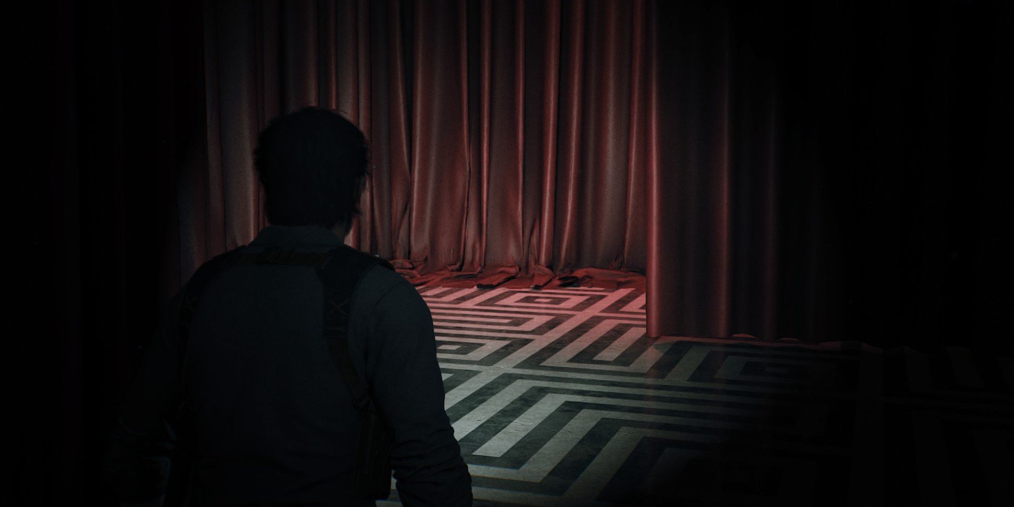 Sebastian walks through a dark hallway with red curtains