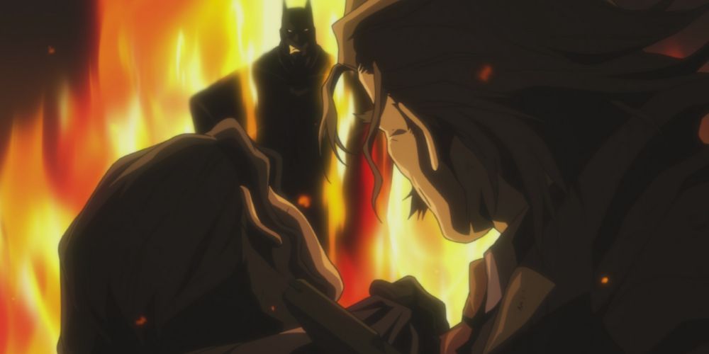 Batman emerges from a wall of fire to confront a man threatening a detective. 