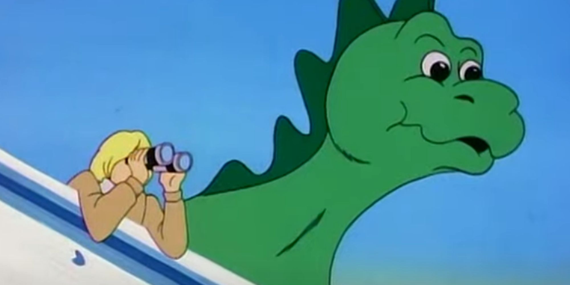 Godzooki looks into the distance with his human companion.