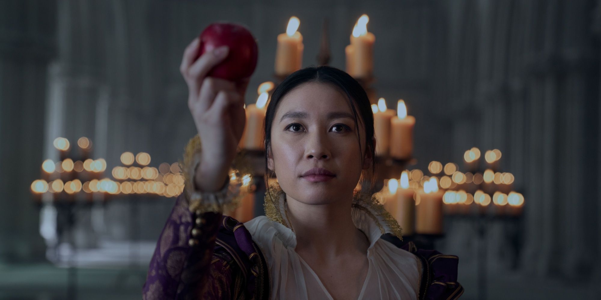 Jess Hong as Jin holding an apple in a cathedral in 3 Body Problem