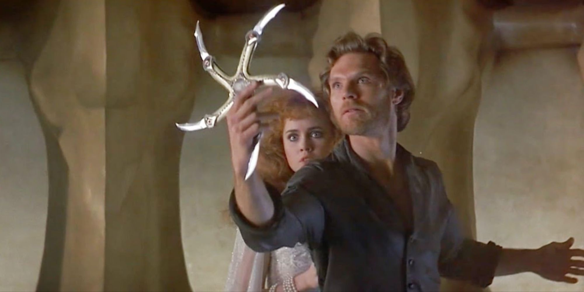 Colwyn holding out the spiked circular blade known as the Glaive in front of Princess Lyssa.