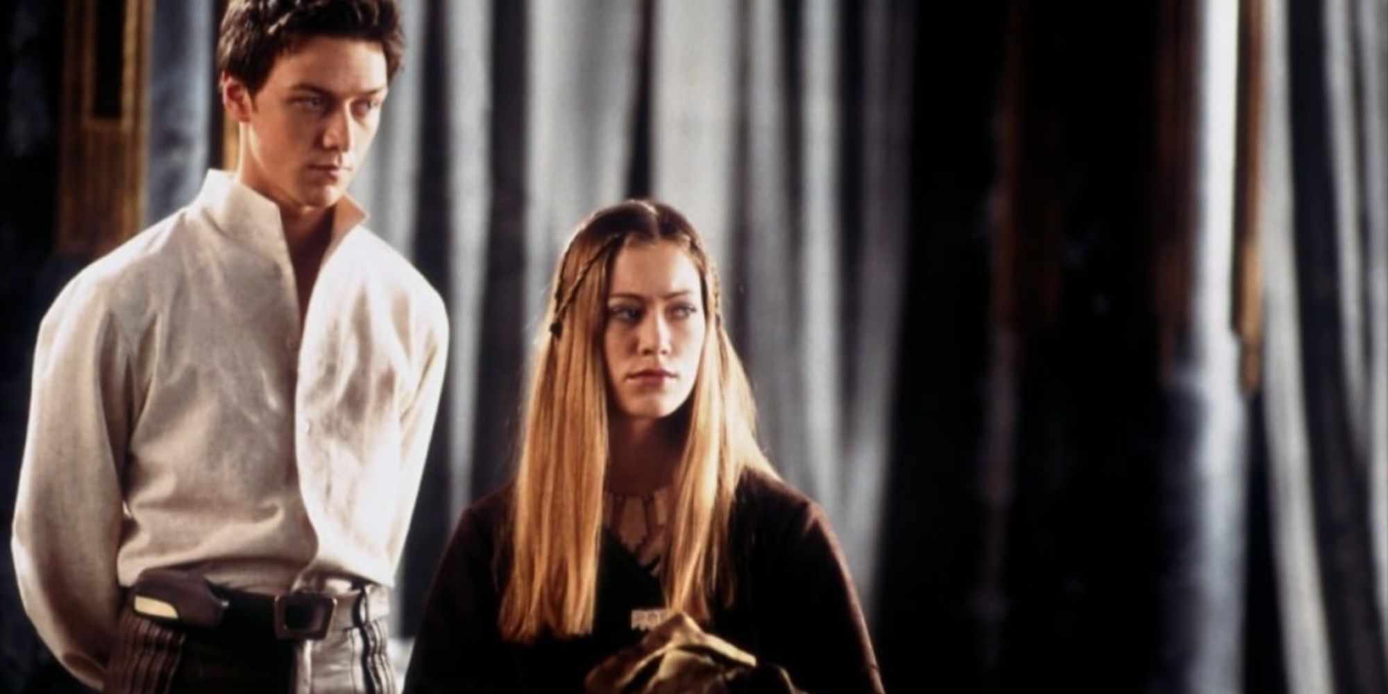 James MacAvoy as Leto II with hands behind his back standing beside his sister Ghanima Atreides, played by Jessica Brooks.
