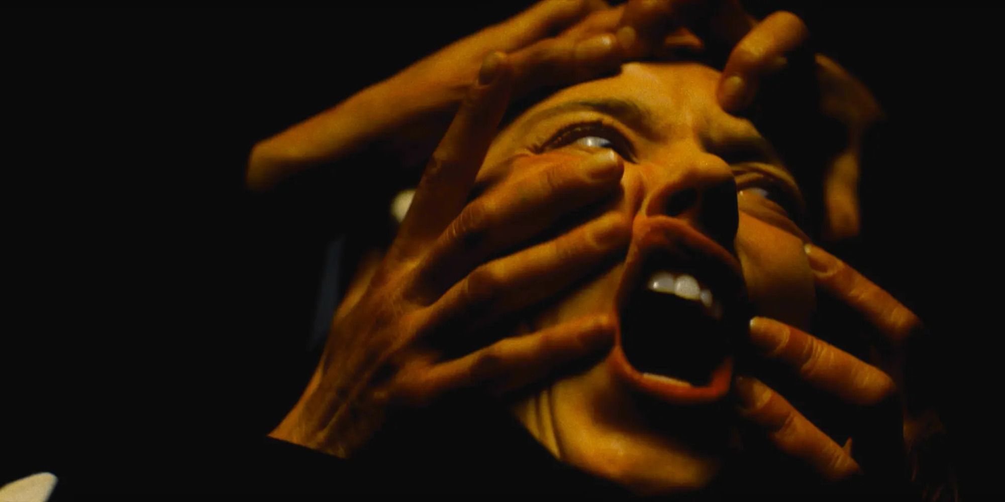 Sydney Sweeney in Immaculate with multiple pairs of hands grabbing her face