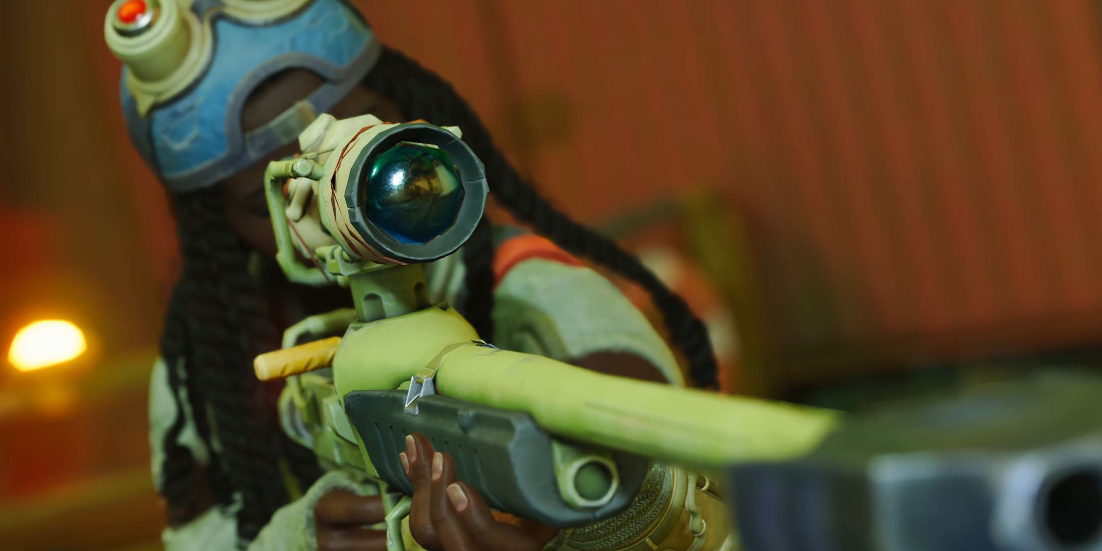 A woman looking down the barrel of a sniper rifle