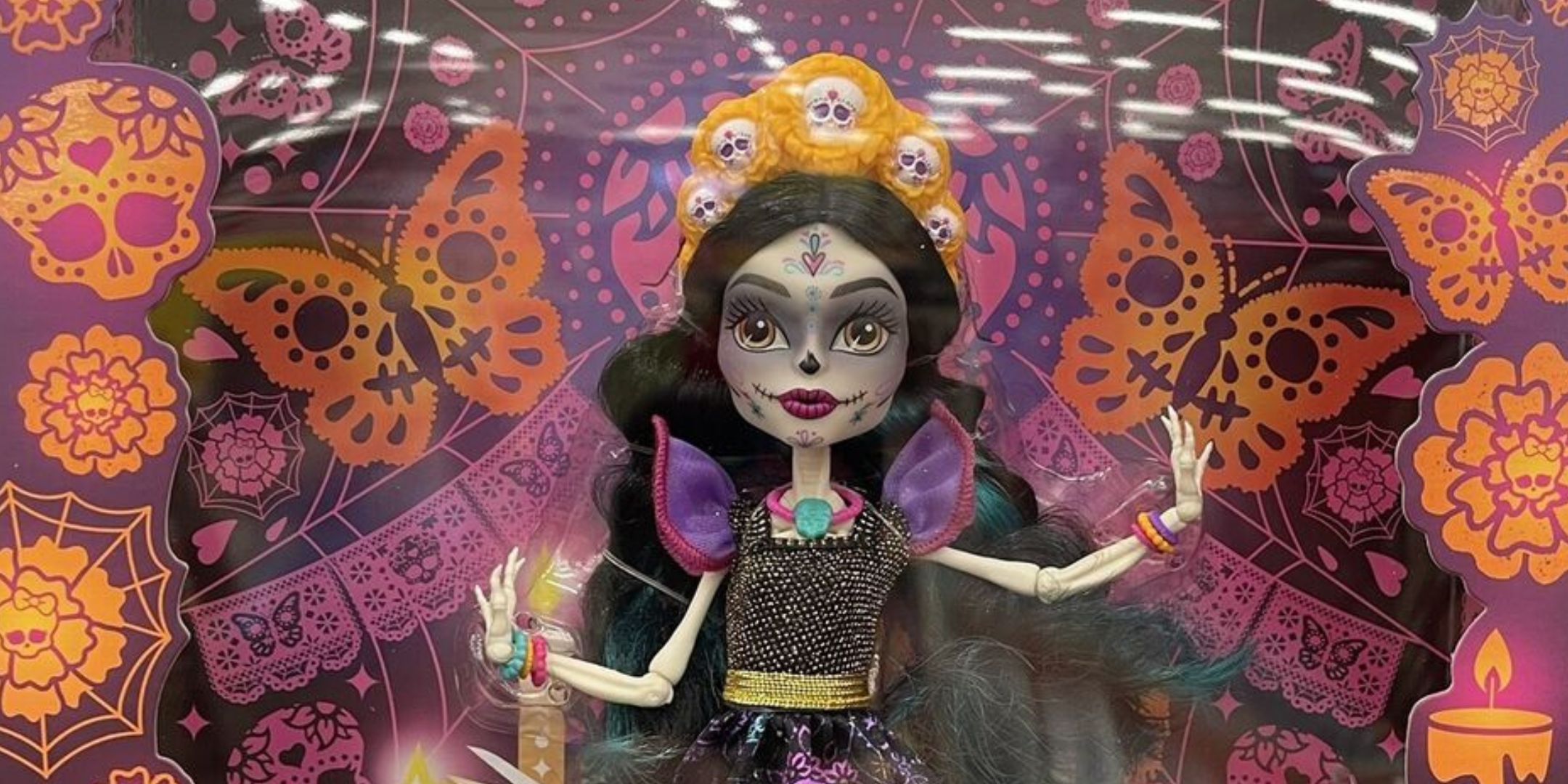 Skelita doll against a patterned orange, pink and purple background