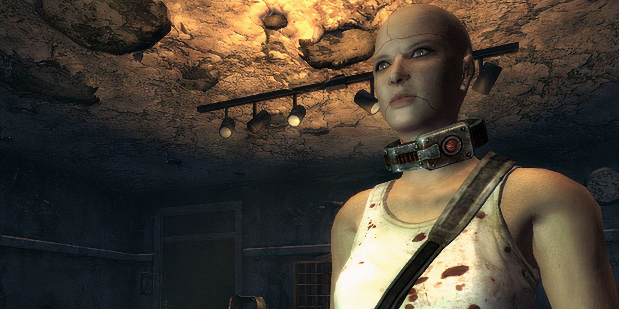 A bald woman with a collar standing in a desolate room