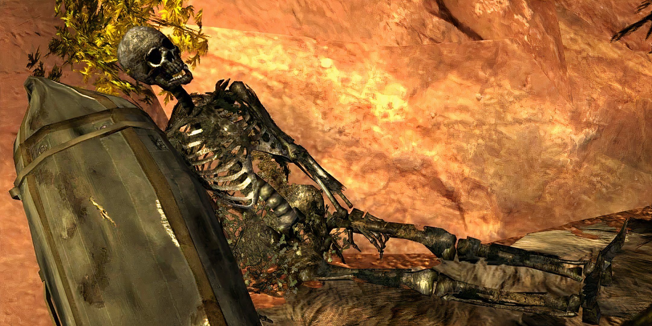 A skeleton lays next to a rucksack in the desert