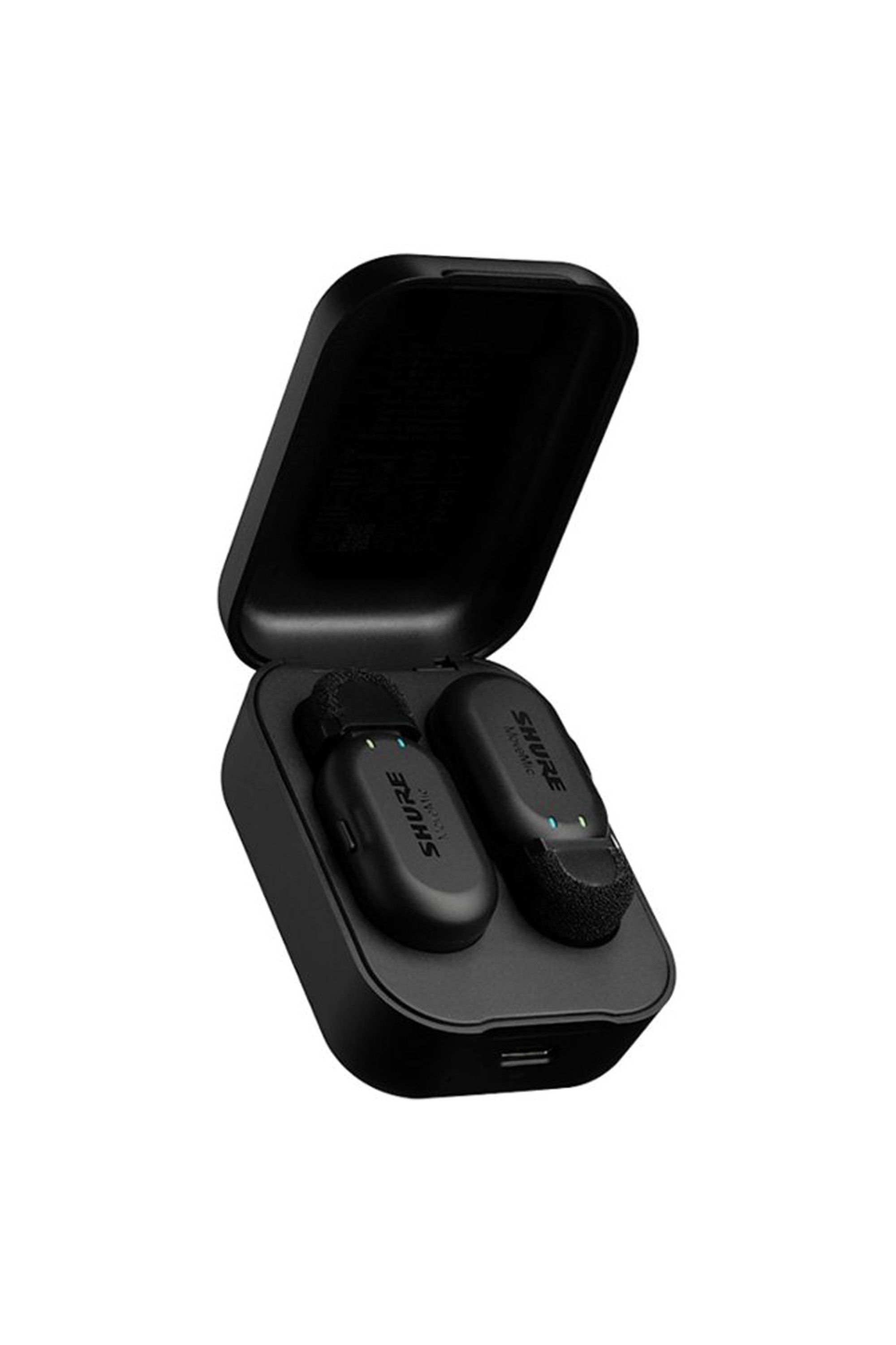 Charging case containing two black Shure MoveMic Two wireless lavalier microphones with foam windscreens.