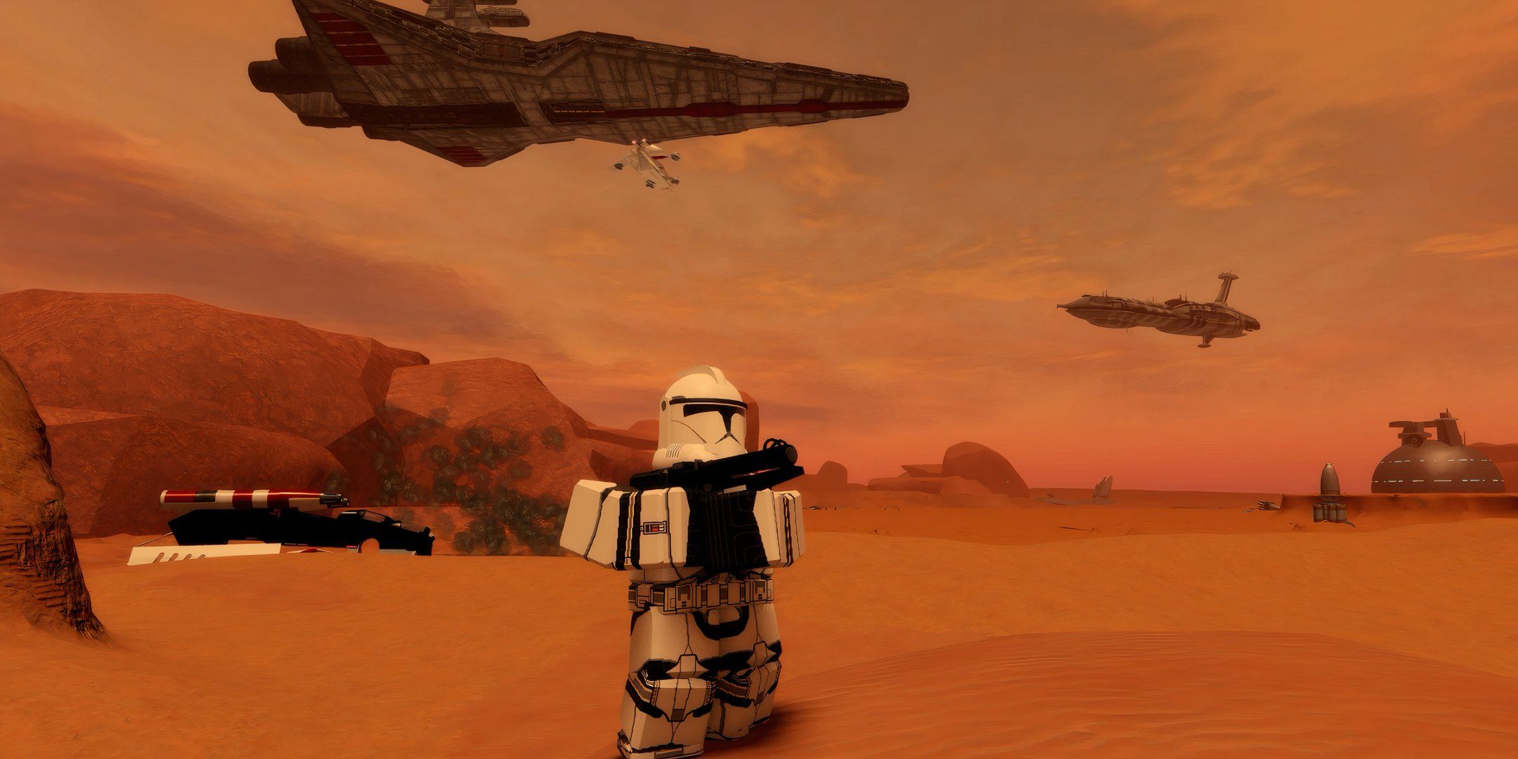 A clone standing in the desert, while large spaceships float in the background behind him