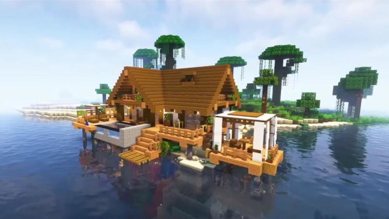 A beach house over the water on stilts in Minecraft, with a suspended swimming pool in the front and a nice table with a roof overhead on the right.