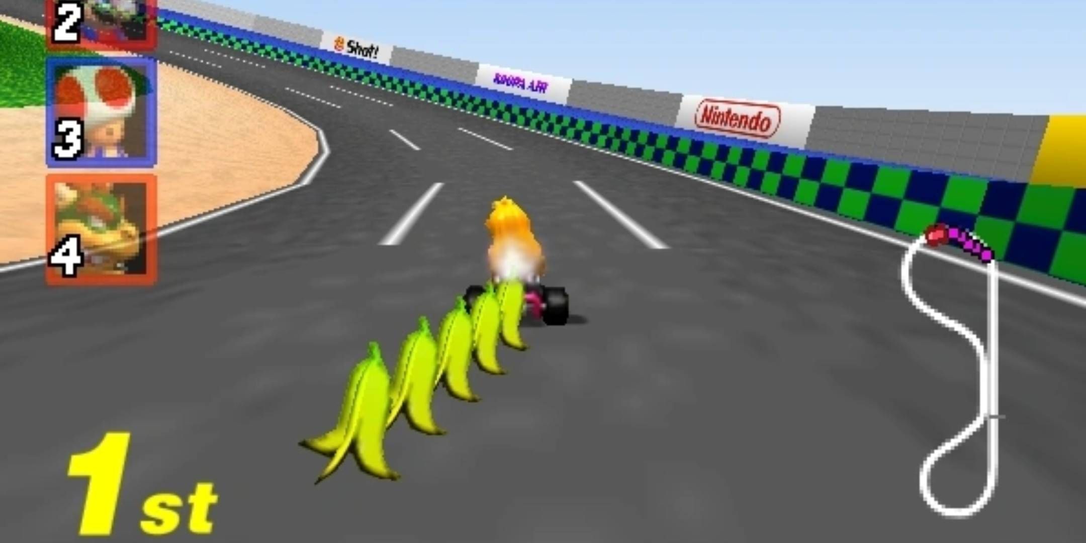 Princess Peach dragging five bananas from the Banana Bunch item on Luigi Raceway in Mario Kart 64.