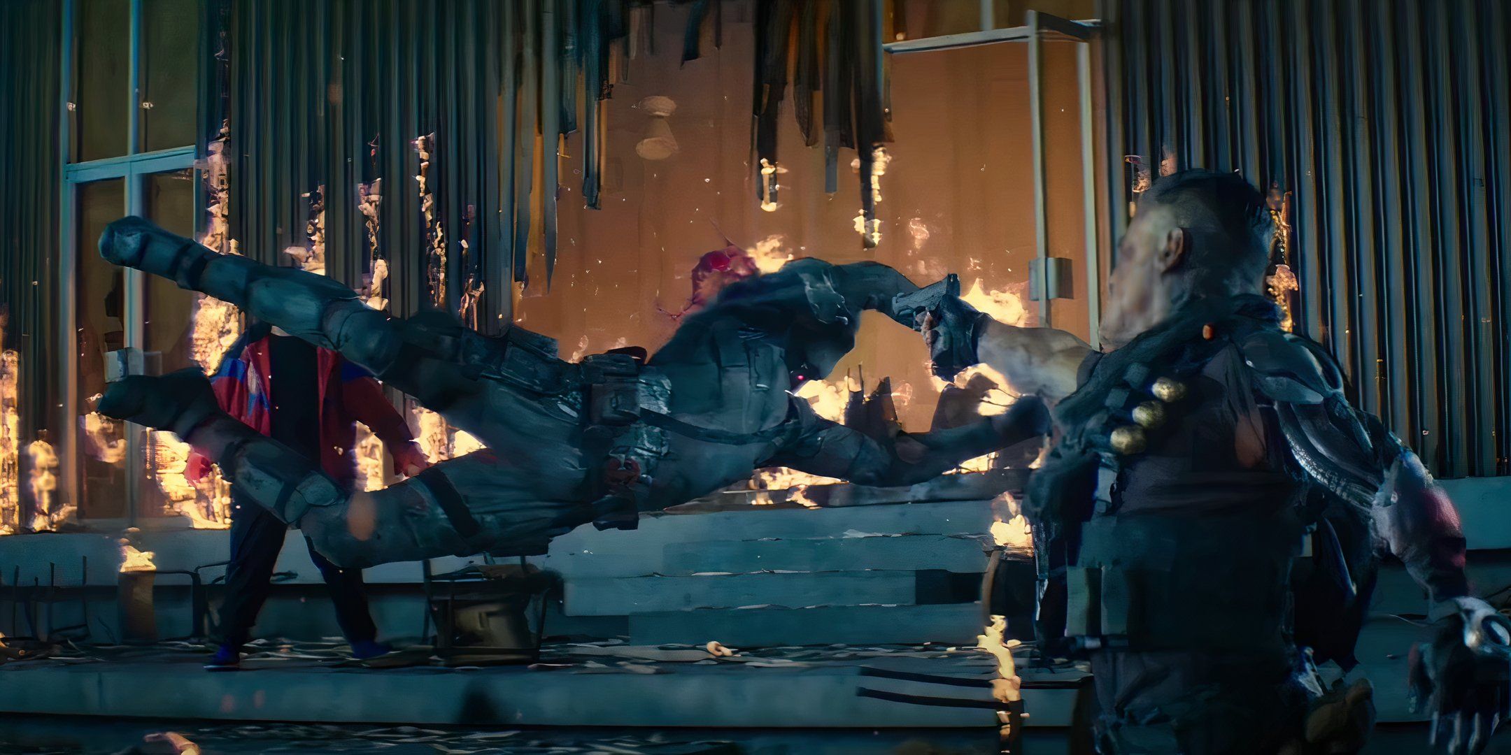 Deadpool 2 movie image showing Deadpool jumping in front of Cable to take the shot of his gun.