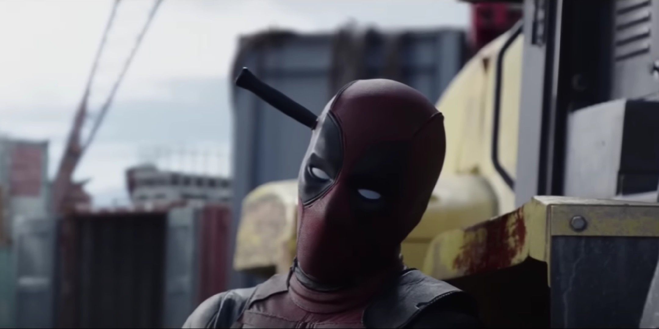Deadpool movie image showing Deadpool with a knife on his head.