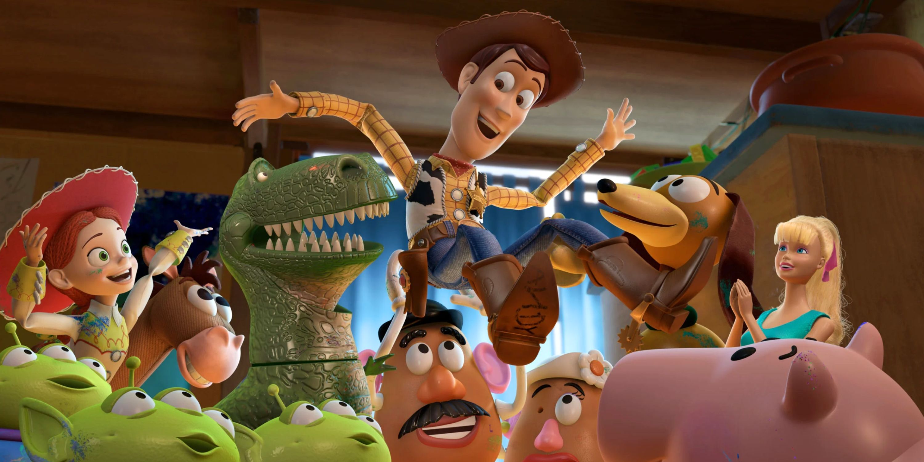 Screenshot from Toy Story movie featuring many characters hoisting Woody up in praise