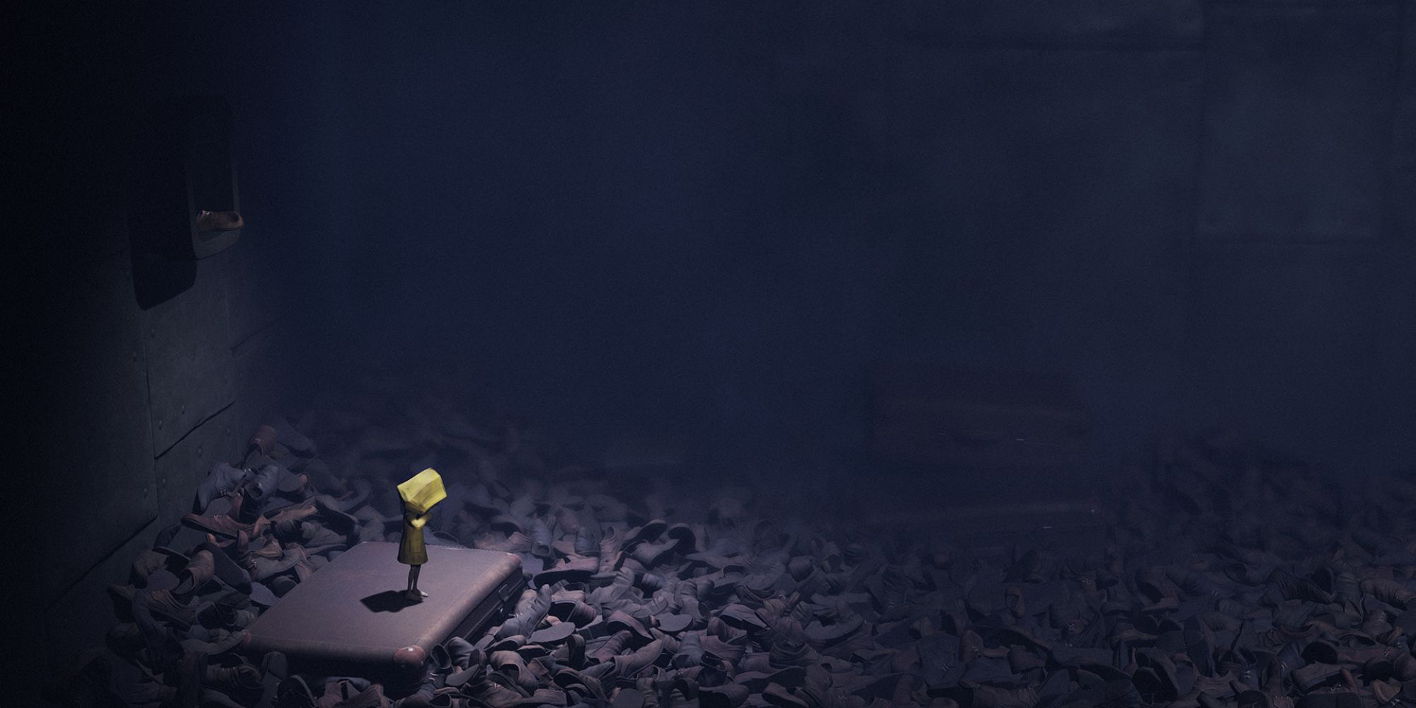 Six is arrouned by piles of shoes in a dimly lit room.