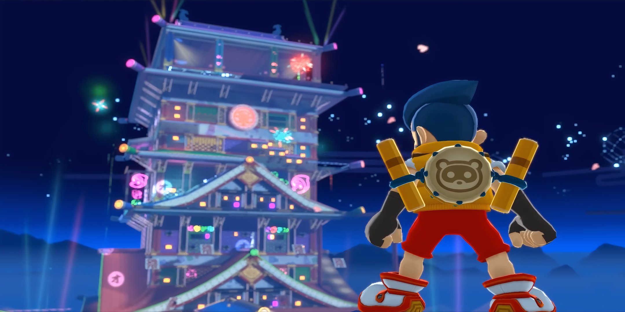 Bakeru standing in front of towering japanese castle with taiko on his back