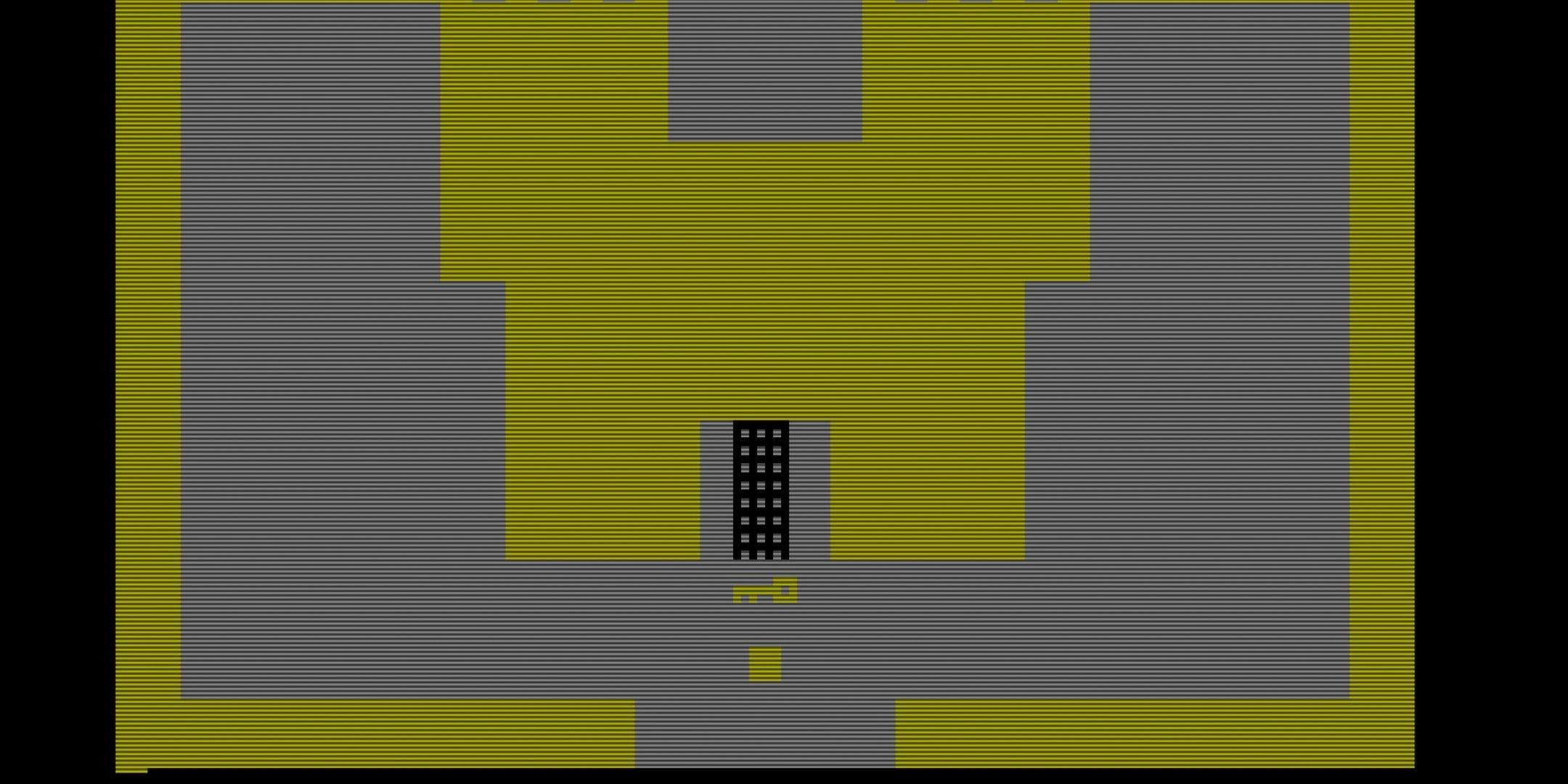 Yellow square holding a key in front of a yellow castle in Adventure.