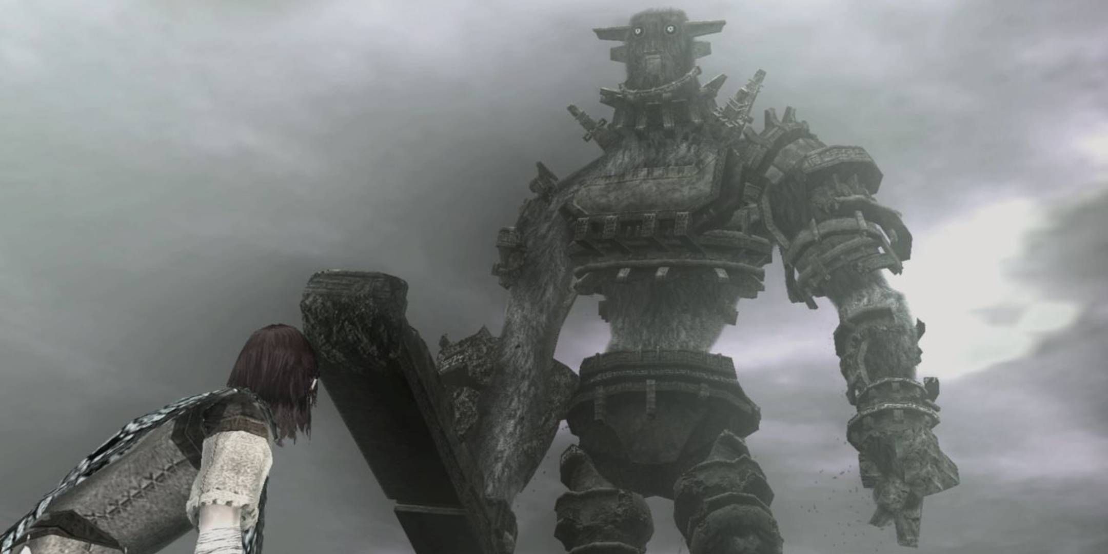 Wander looking up at a colossi in Shadow of the Colossus.