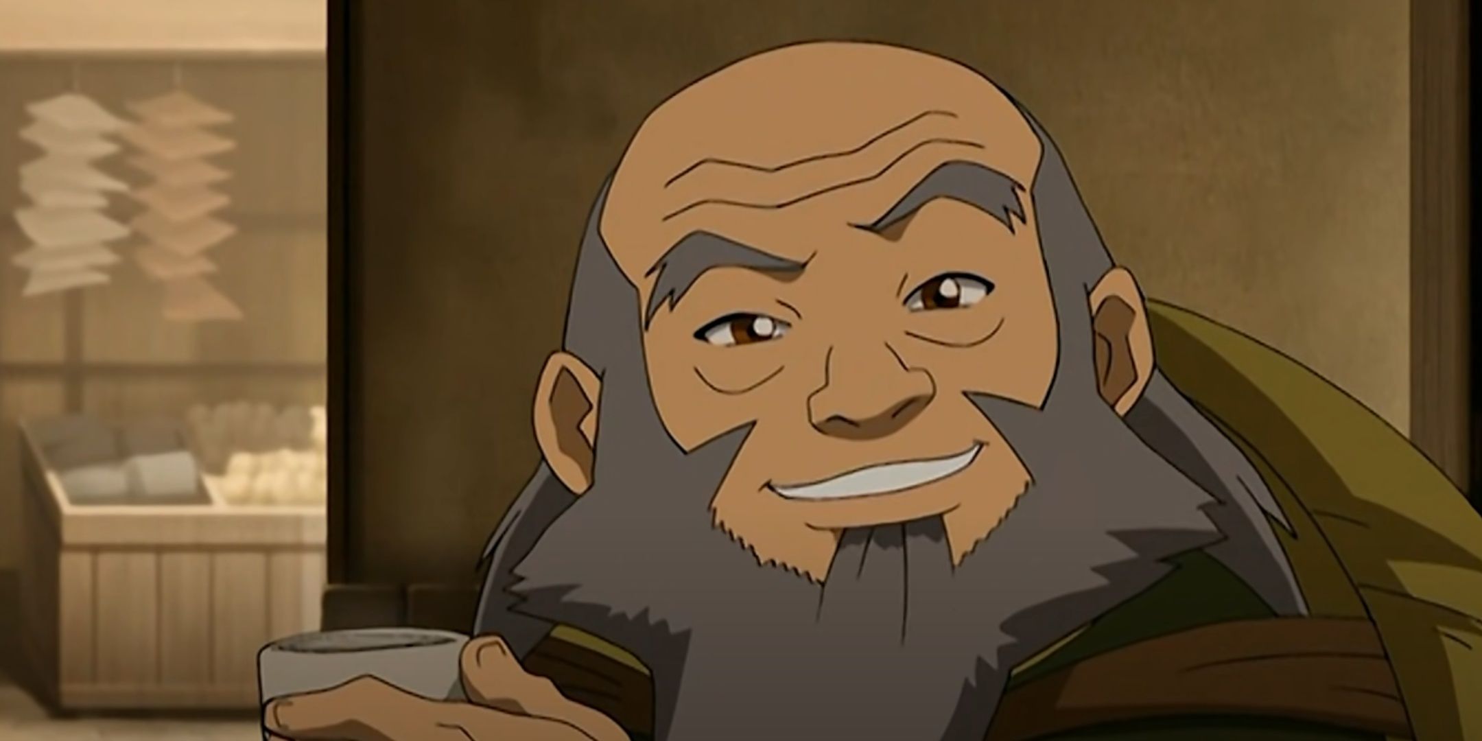 Iroh smiles as he drinks tea.