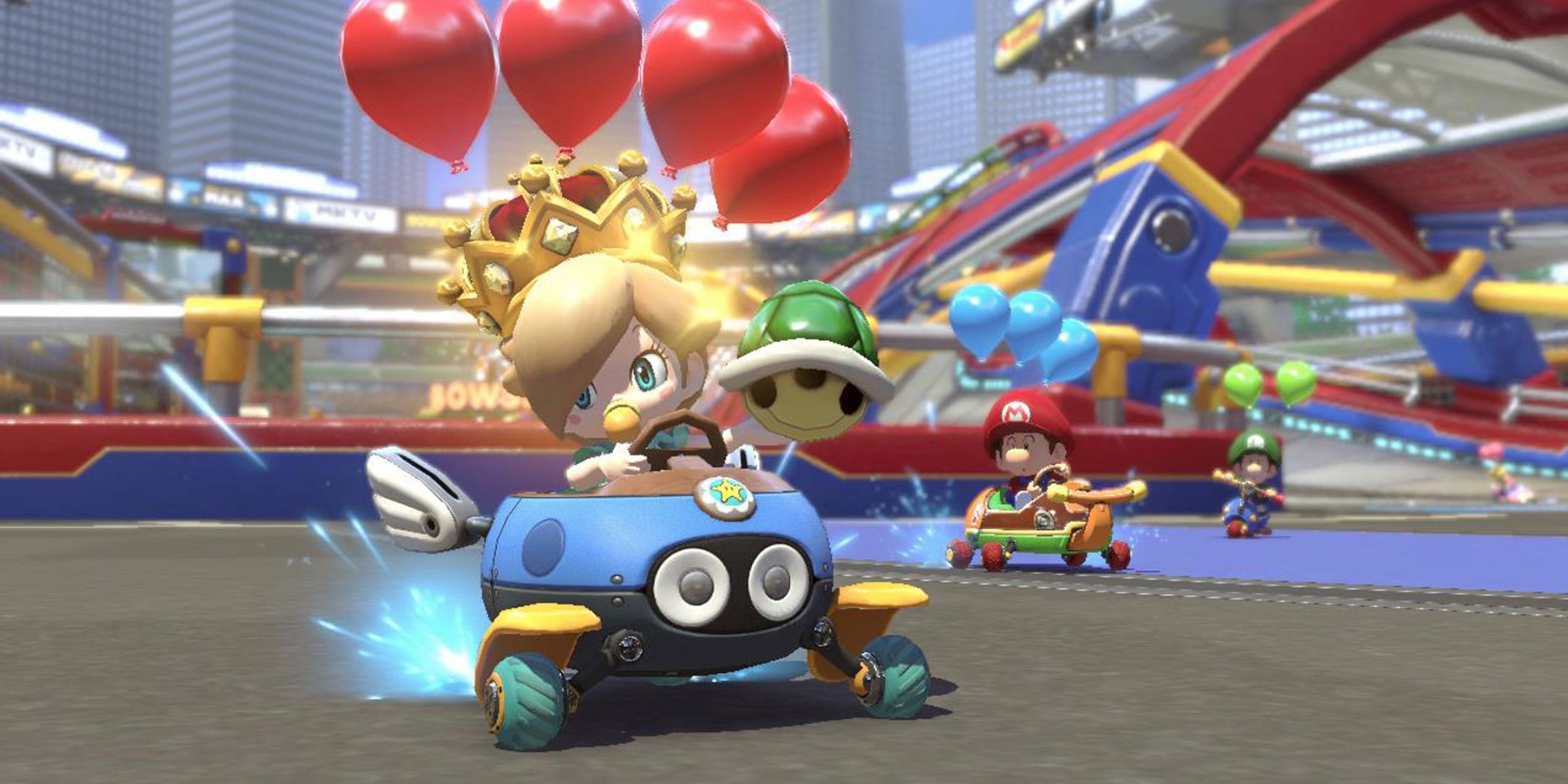 Baby Rosalina, Baby Mario, and Baby Luigi racing through a battle course in Mario Kart 8 Deluxe.