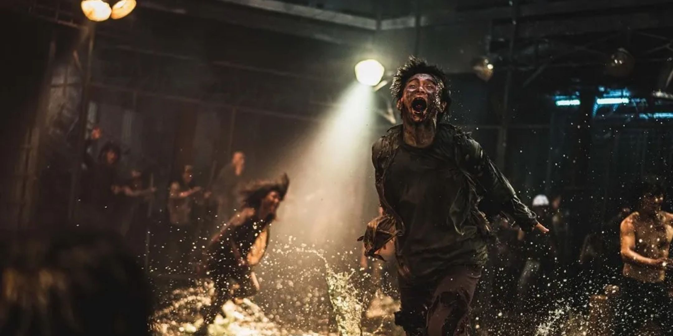 Zombies flail around in water, chained up. 